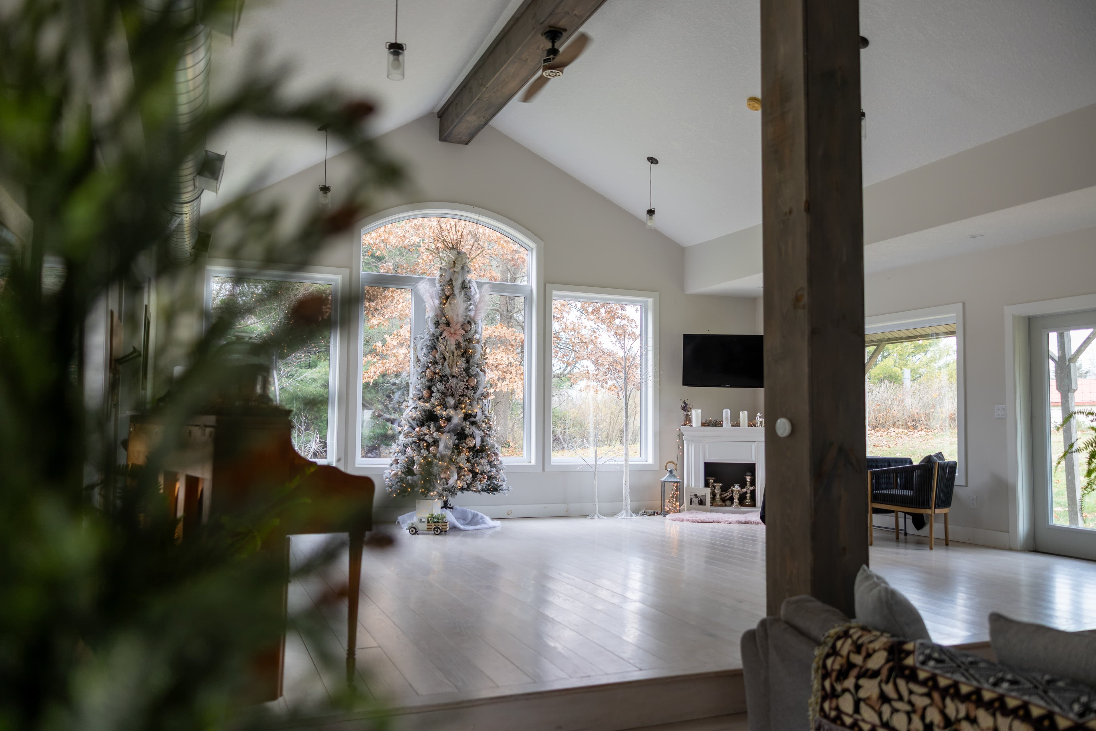 Bright vaulted living with huge windows, fireplace, and scenic views